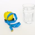 glass of water, lemon and measuring tape